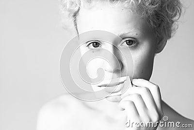 Tender young girl closes her lips to picture painted lips. Stock Photo