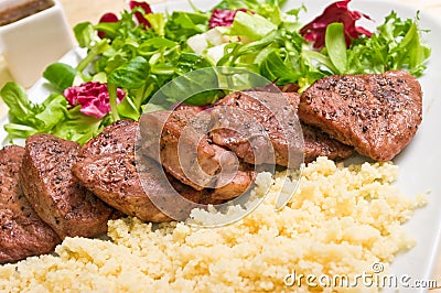 Tenderloin steaks and kuskus groats Stock Photo