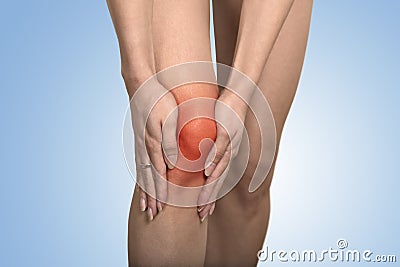 Tendon knee joint problems on woman leg indicated with red spot Stock Photo