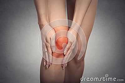 Tendon knee joint problems on woman leg indicated with red spot Stock Photo