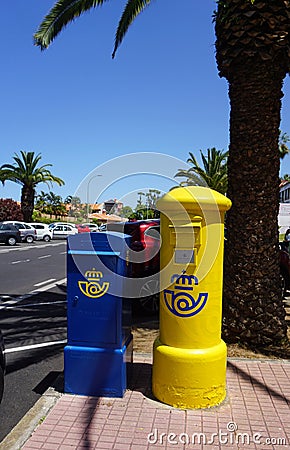 Tenerife, Canary Islands, Spain - April 14, 2023: Blue and yellow pillar postboxes with Correos logo in Puerto de la Cruz Editorial Stock Photo