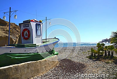 Tenerife,Canary Islands,Spain - March 15,2019:View of Tajao village with traditional old wooden fishing boat on the rocky beach. Editorial Stock Photo