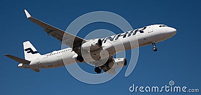 Finnair Airlines flies in the blue sky. Landing at Tenerife Airport Editorial Stock Photo