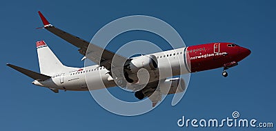 Tenerife, Spain January 3 st, 2024. Boeing 737 MAX 8 Norwegian Airlines flies in the blue sky Editorial Stock Photo