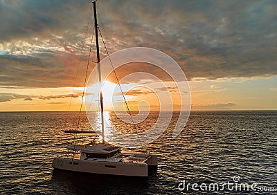 Lonely modern yacht in calm waters of open Atlantic Ocean at sunset Editorial Stock Photo