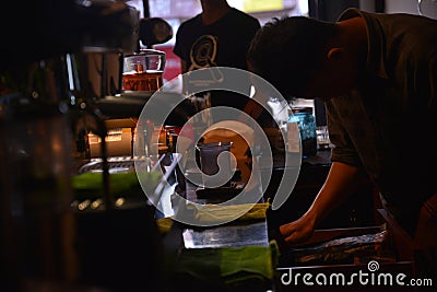 TENGGARONG, INDONESIA - MEI 2017 : Handsome barista cafe coffee preparing cup and making of coffee Service Concept for customer in Editorial Stock Photo