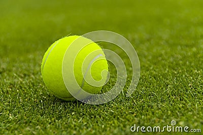 Tennis ball on a lawn court Stock Photo