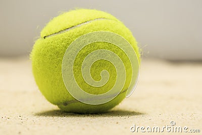 Tennis ball in the sand Stock Photo