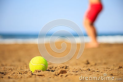 Tennis ball on a sandy beach Stock Photo