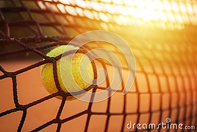 Tennis ball in the tennis net Stock Photo