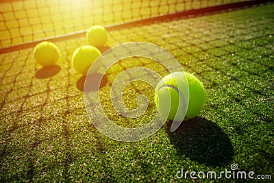 Tennis balls on grass court with sunlight Stock Photo