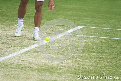 Tennis player bouncing ball Stock Photo