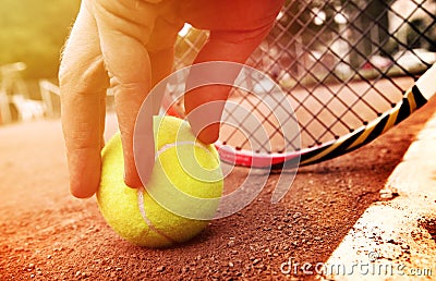 Tennis player gets the ball Stock Photo