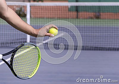 Tennis player with racket and ball on purple hard tennis court prepares to serve. Start of game, match. copy space Stock Photo