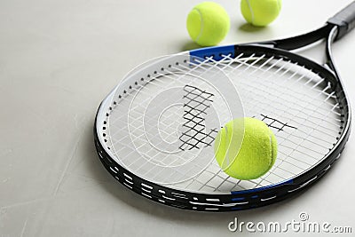 Tennis racket and balls on grey table. Sports equipment Stock Photo