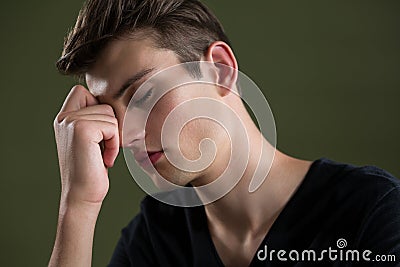 Tense androgynous man with hand on forehead Stock Photo