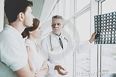 Tense Male Doctor Indicates on Image of Roentgen. Stock Photo