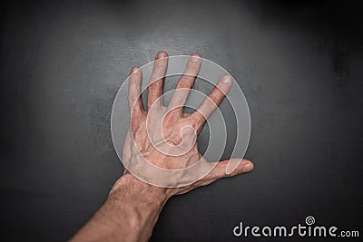 Tense male palm with veins on a black background Stock Photo