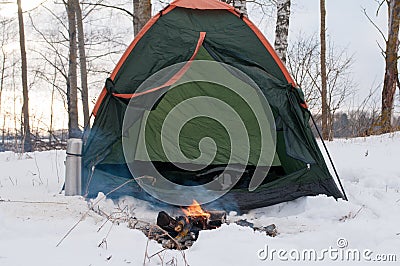 Tent and campfire in the snow, camping in winter, Stock Photo