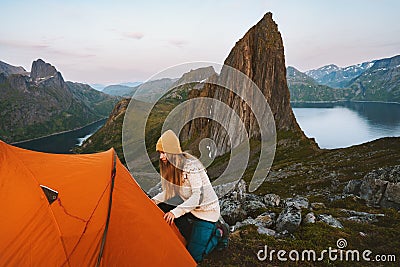 Tent camping in mountains hiker woman traveling in Norway alone Stock Photo