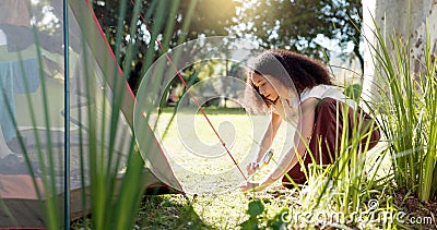 Tent, nature and woman with a setup for a camp in a forest for holiday or adventure. Vacation, outdoor and a young girl Stock Photo