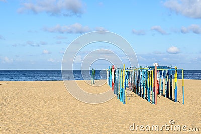 Tent poles on the beach, Nazare (Portugal) Stock Photo