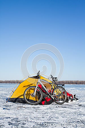 Tent winter mountains.Tent stands in the mountains in the snow. Snowshoes are beside the tent. Stock Photo