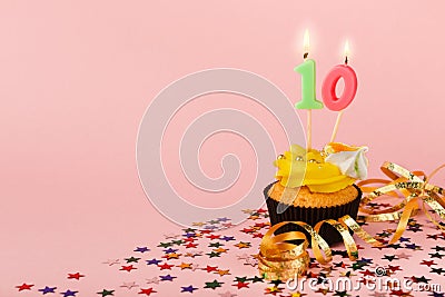 Tenth birthday cupcake with candle and sprinkles Stock Photo