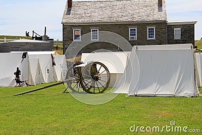 Tents and artillery set up in front of stone buildings during reenactments, Fort Ontario, New York, 2016 Editorial Stock Photo