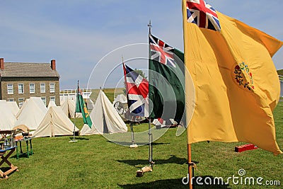 Tents and flags set up in front of stone buildings during reenactments, Fort Ontario, New York, 2016 Editorial Stock Photo