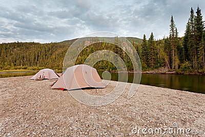 Tents at river in remote Yukon taiga wilderness Stock Photo