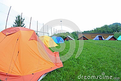 Tents scout campers in a green meadow Stock Photo