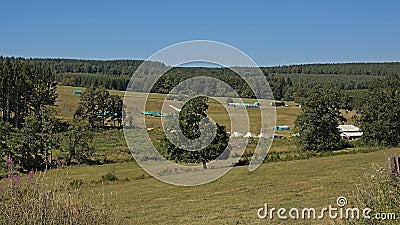 Tents of a scouts camp in a meadow in the hills of Ardennes, Belgium Stock Photo