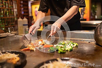 Teppanyaki Chef Cooking and Cutting Up Vegetables Stock Photo