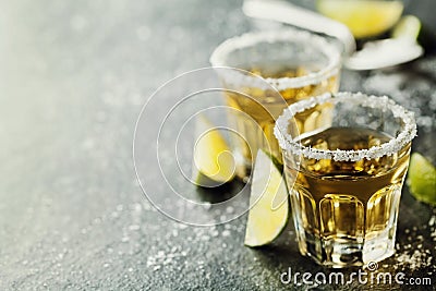 Tequila shot with lime and sea salt on black table Stock Photo