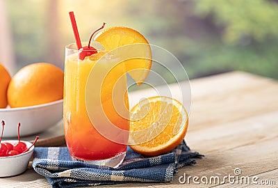 Tequila sunrise cocktail with orange slice and cherry Stock Photo