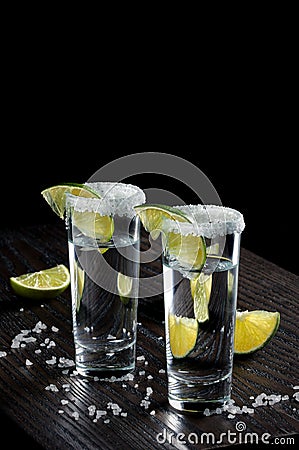 Tequila tall shot glasses with lime Stock Photo