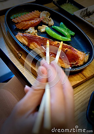 Teriyaki salmon pan fried on the wooden. Stock Photo