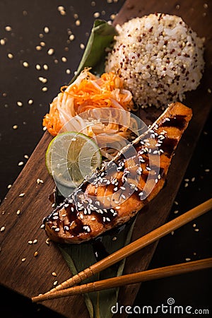 Teriyaki salmon with rice on a wooden platter. Top Stock Photo