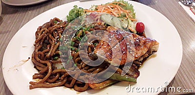 Teriyaki sesame udon with salmon very delicious my daughter favourites Stock Photo