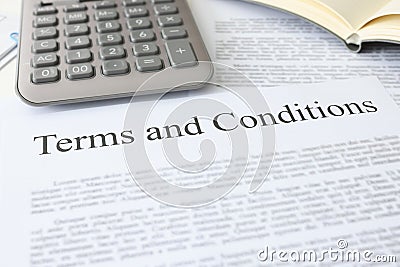 Terms conditions document with calculator lies on table Stock Photo