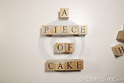 In terms of easy work, A piece of cake. Written from wooden cubes Stock Photo