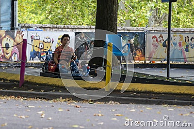Child at the park going on the electric car track Editorial Stock Photo