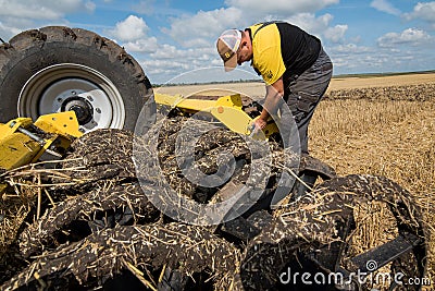 TERNOPIL REGION, UKRAINE - August 10, 2021: man inspect and configures cultivator on demonstration of agricultural machinery, Editorial Stock Photo