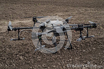 TERNOPIL REGION, UKRAINE - May 06, 2023 - New drone sprayer DJI AGRAS T30 on the background of a plowed field, unpacking, Editorial Stock Photo