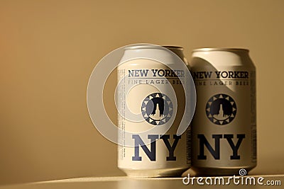 TERNOPIL, UKRAINE - JULY 18, 2022 Two cans of New Yorker fine lager beer with original logo and design on brown retro background Editorial Stock Photo