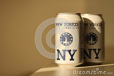 TERNOPIL, UKRAINE - JULY 18, 2022 Two cans of New Yorker fine lager beer with original logo and design on brown retro background Editorial Stock Photo