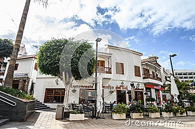 The terrace of the restaurant with the visitors in the city centre. Selective focus. 20.01.2020 Los Gigantes, Tenerife Editorial Stock Photo