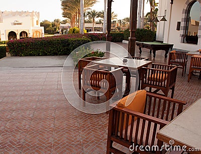 Terrace with tables and chairs. Summer cafe terrace. Exterior place for lunch nopeople Editorial Stock Photo