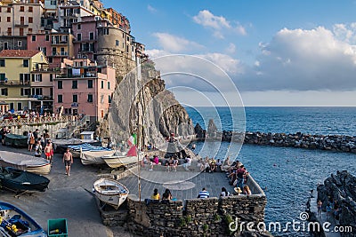 Manarola ITALY - 2 August 2023 - Terrace in viewpoint with people looking at the sea in the bay Editorial Stock Photo